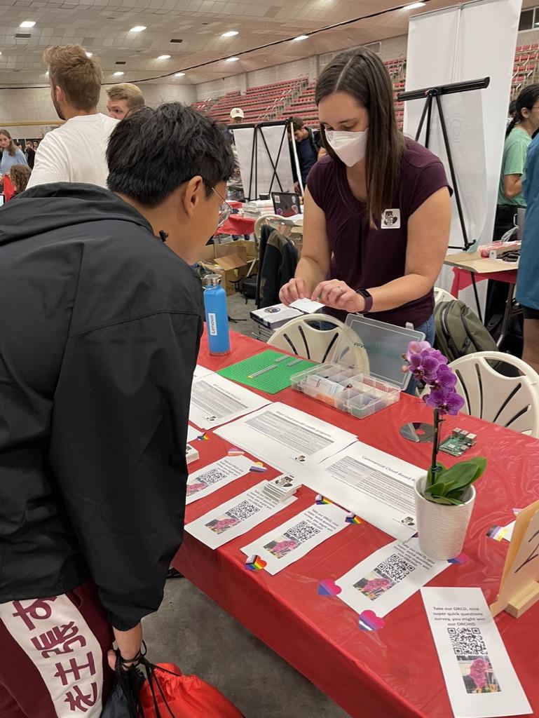 Lauren demonstrates scheduling concepts at the graduate student fair.